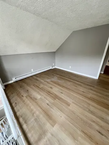 a bathroom with a sink a toilet a mirror and shower