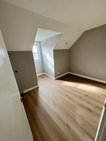 a view of an empty room and wooden floor