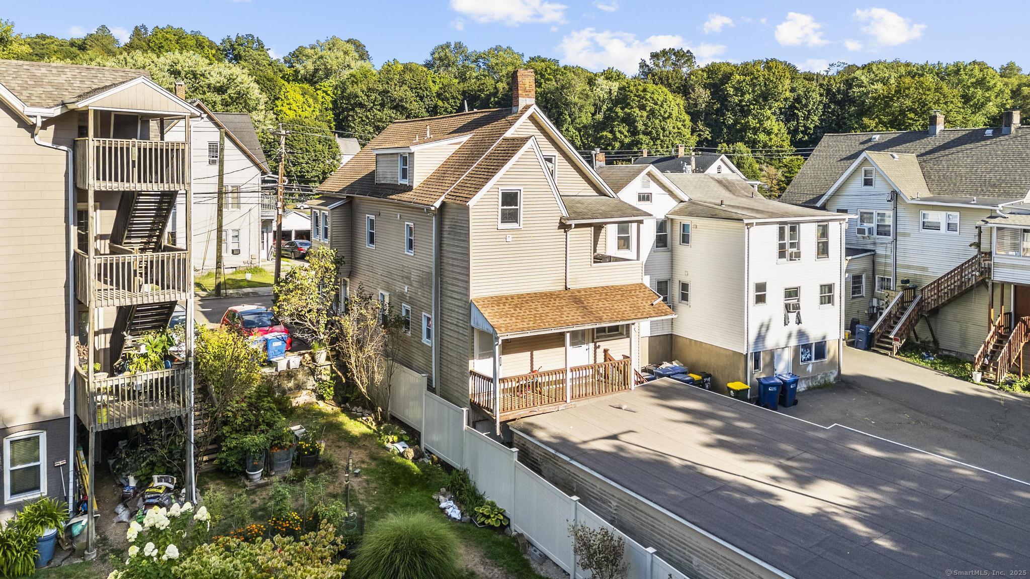 121 North State Street Ansonia, CT 06401 - Photo 6 of 37 a view of a white house with a small yard and potted plants