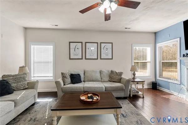 a living room with furniture a rug and a window