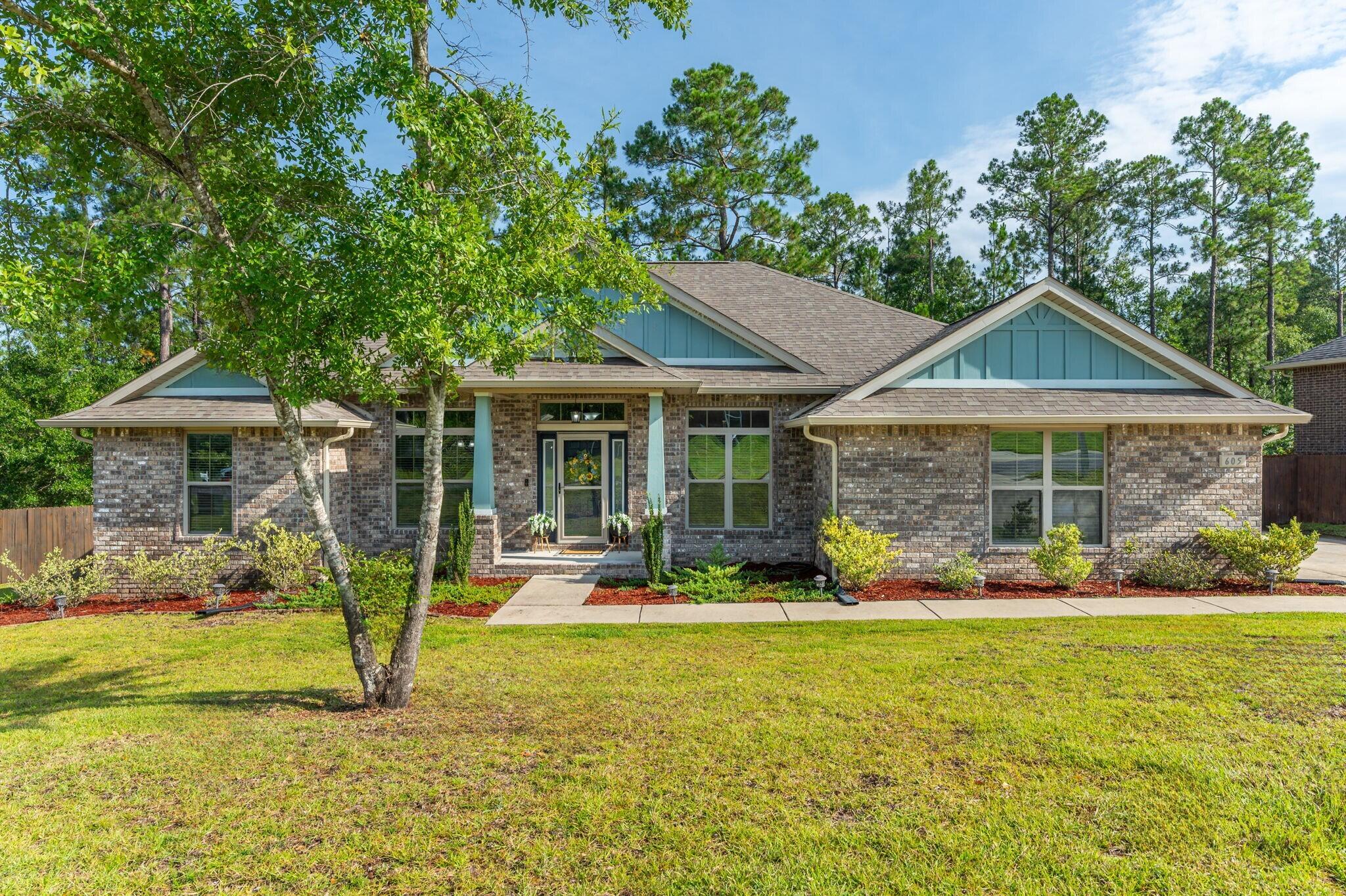 605 Terrier Trail Crestview, FL 32536 - Photo 1 of 46 a front view of a house with garden