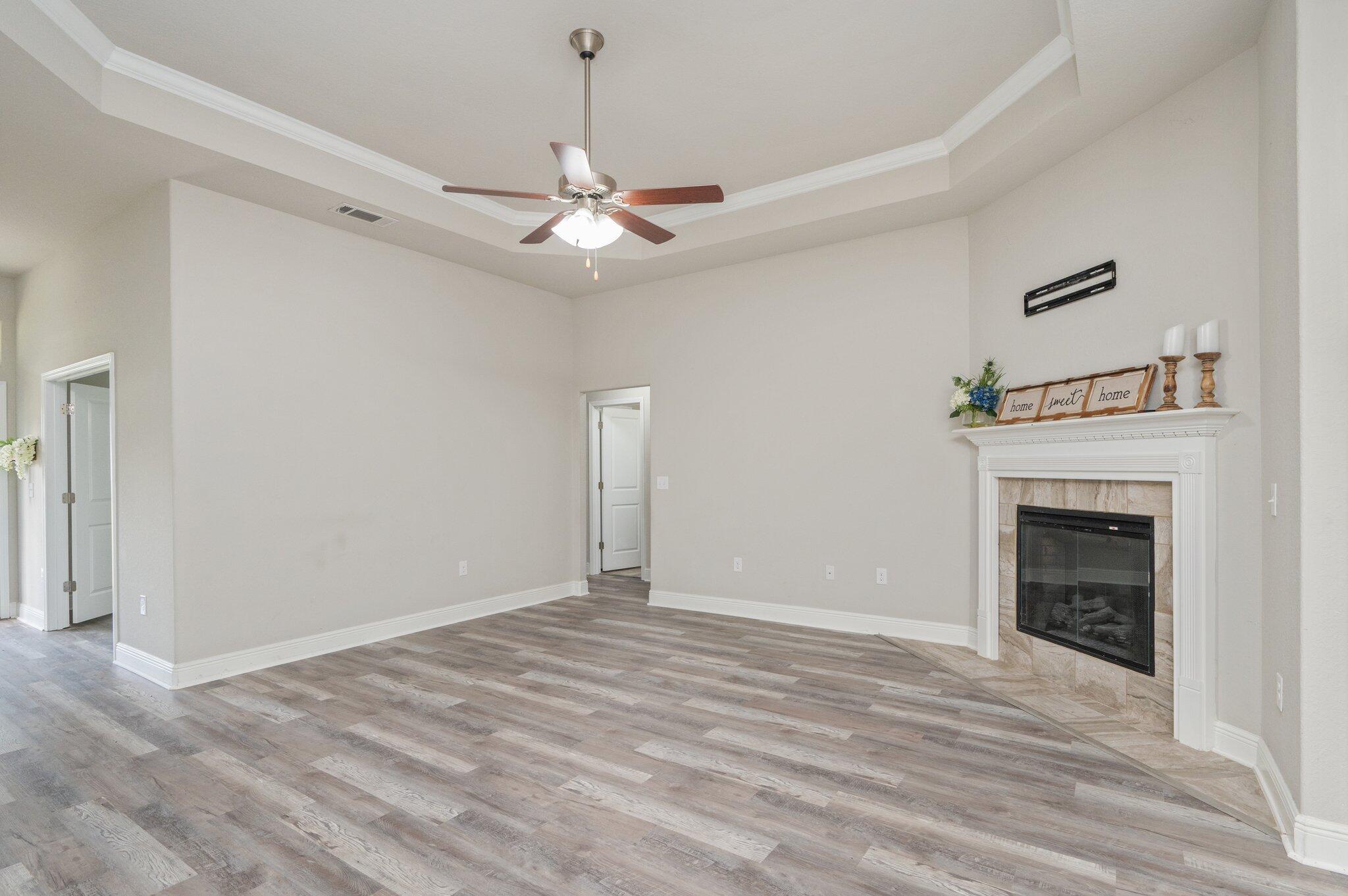 605 Terrier Trail Crestview, FL 32536 - Photo 14 of 46 a view of empty room with fireplace and fan