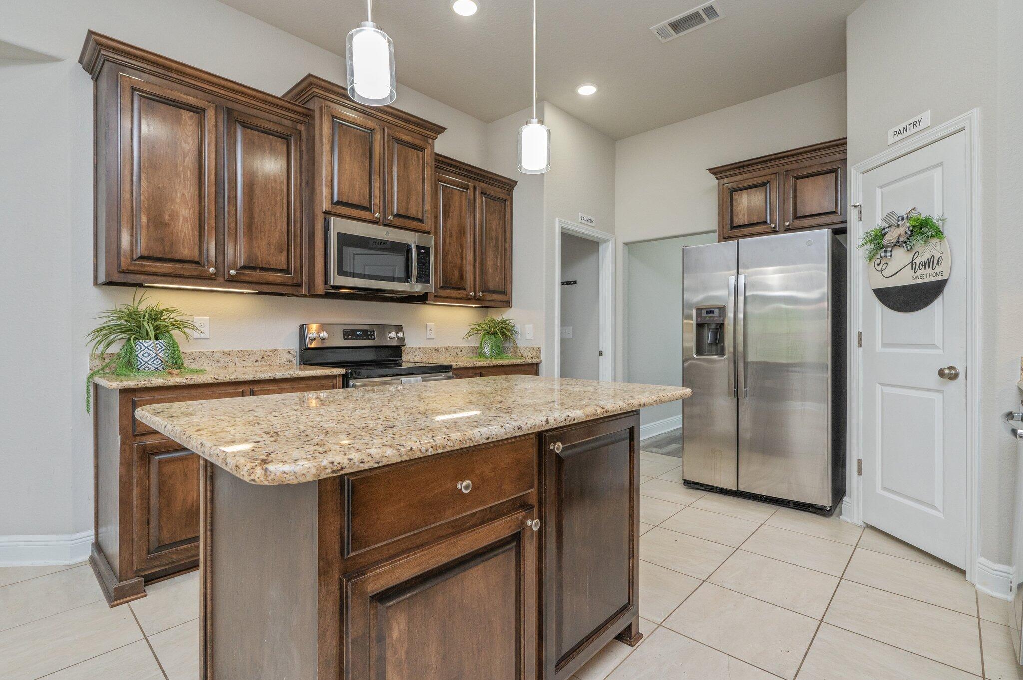 605 Terrier Trail Crestview, FL 32536 - Photo 17 of 46 a kitchen with stainless steel appliances granite countertop a refrigerator stove and microwave
