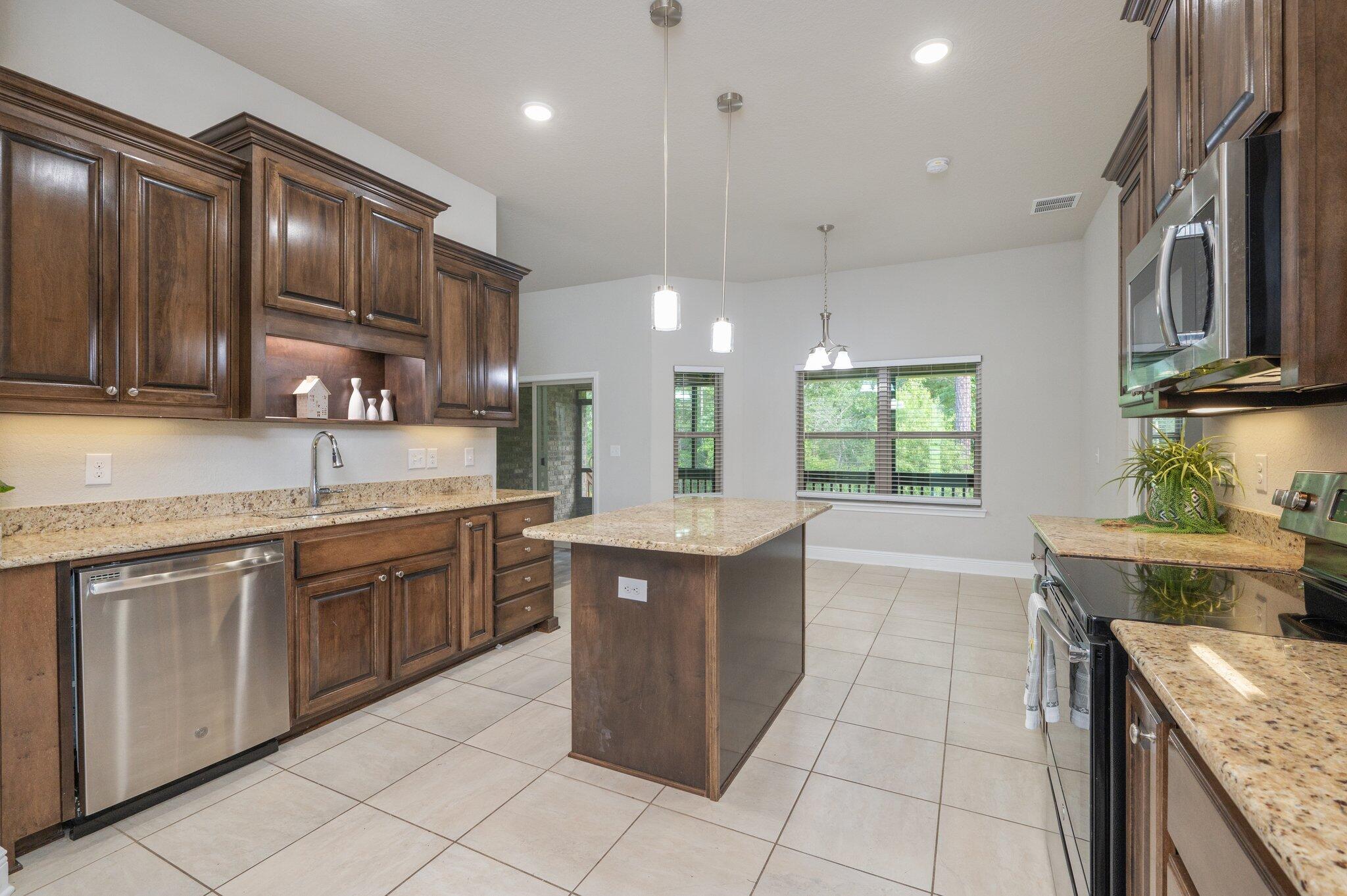 605 Terrier Trail Crestview, FL 32536 - Photo 20 of 46 a kitchen with a sink stove and cabinets