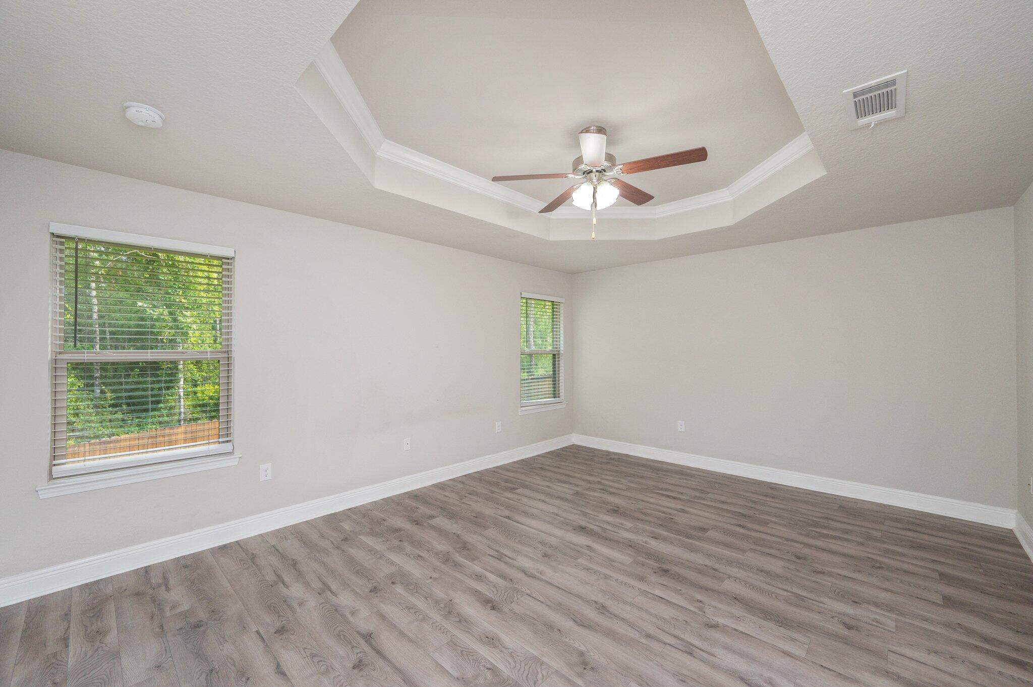 605 Terrier Trail Crestview, FL 32536 - Photo 22 of 46 a view of an empty room with a window and wooden floor