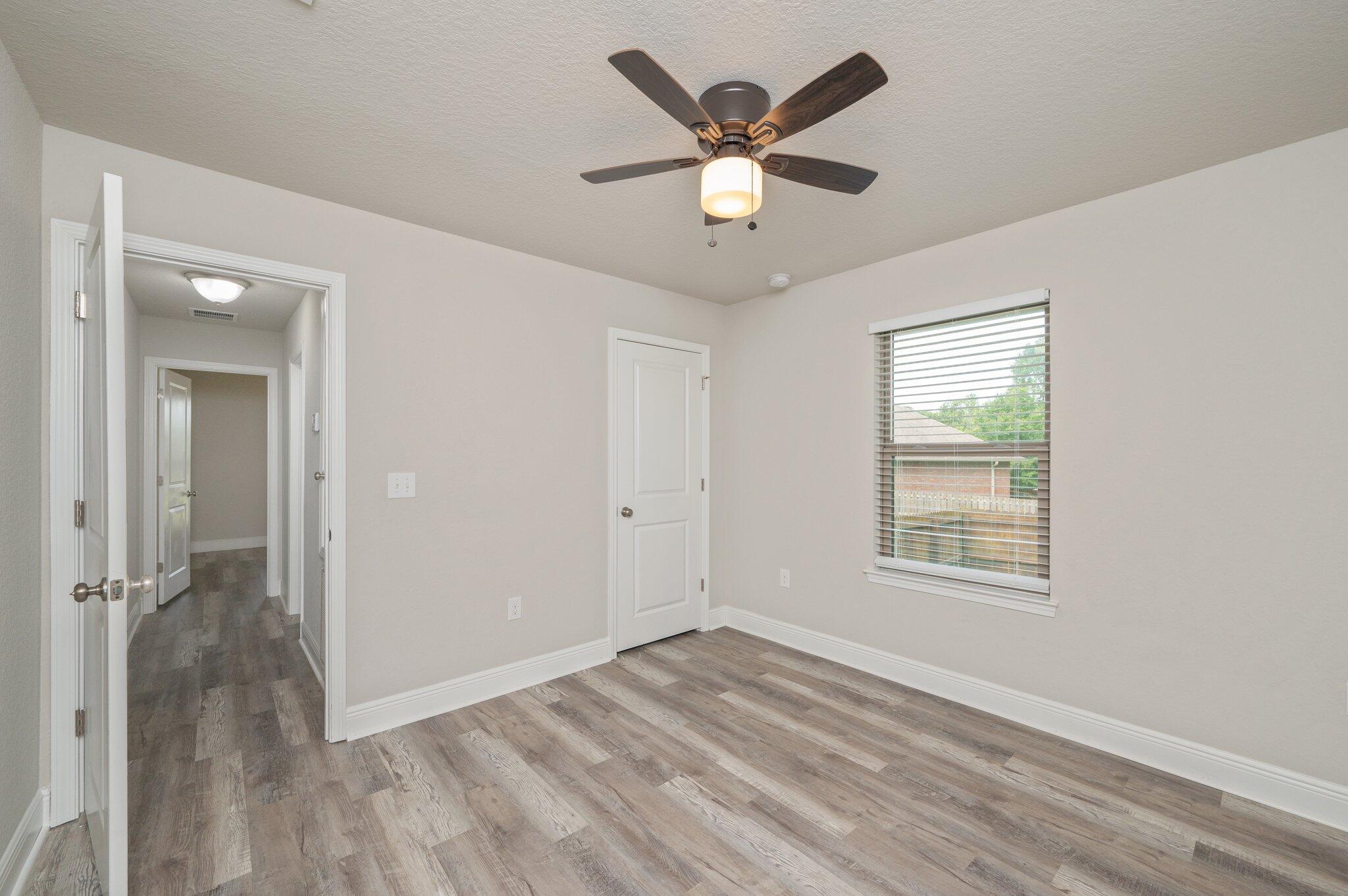 605 Terrier Trail Crestview, FL 32536 - Photo 31 of 46 wooden floor in an empty room with a window