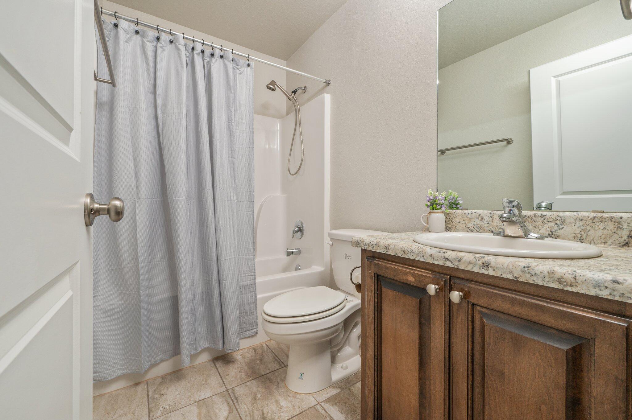 605 Terrier Trail Crestview, FL 32536 - Photo 32 of 46 a bathroom with a granite countertop sink toilet and shower
