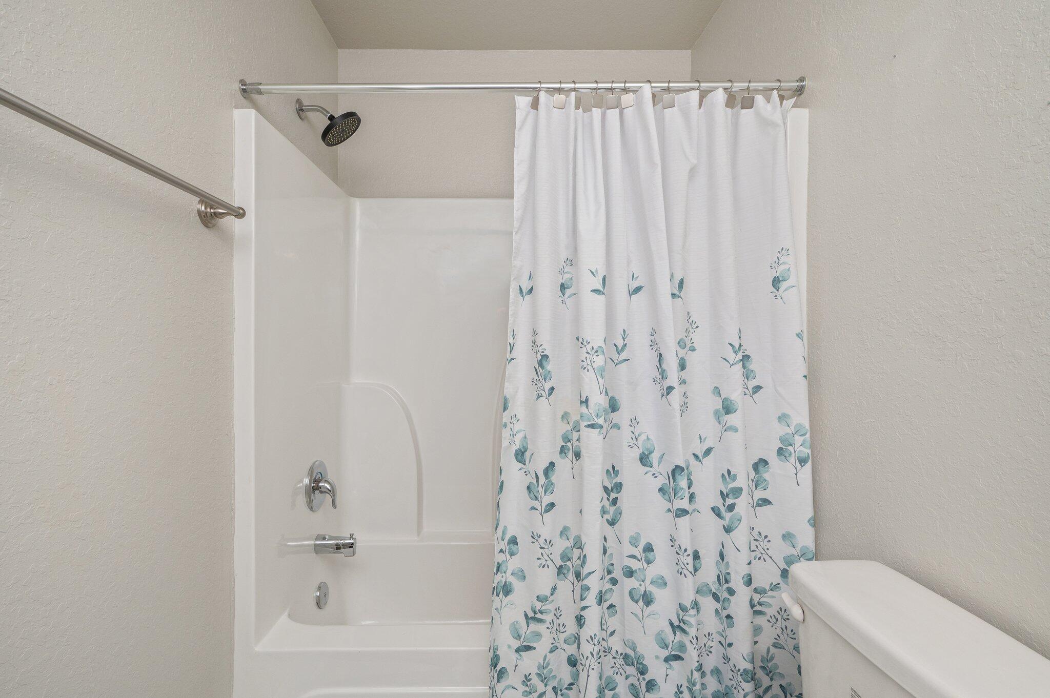 605 Terrier Trail Crestview, FL 32536 - Photo 35 of 46 a bathroom with a shower curtain and a toilet