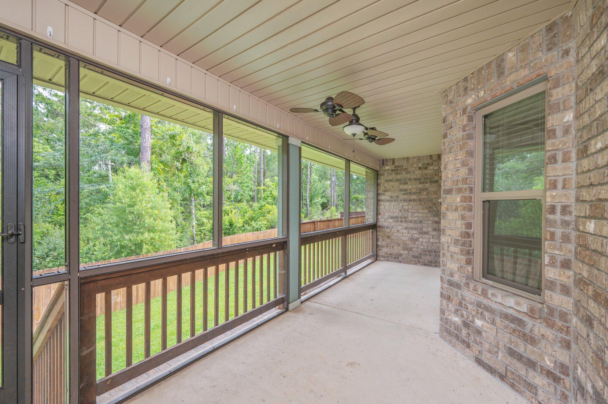 605 Terrier Trail Crestview, FL 32536 - Photo 36 of 46 a view of a porch with furniture and floor to ceiling window