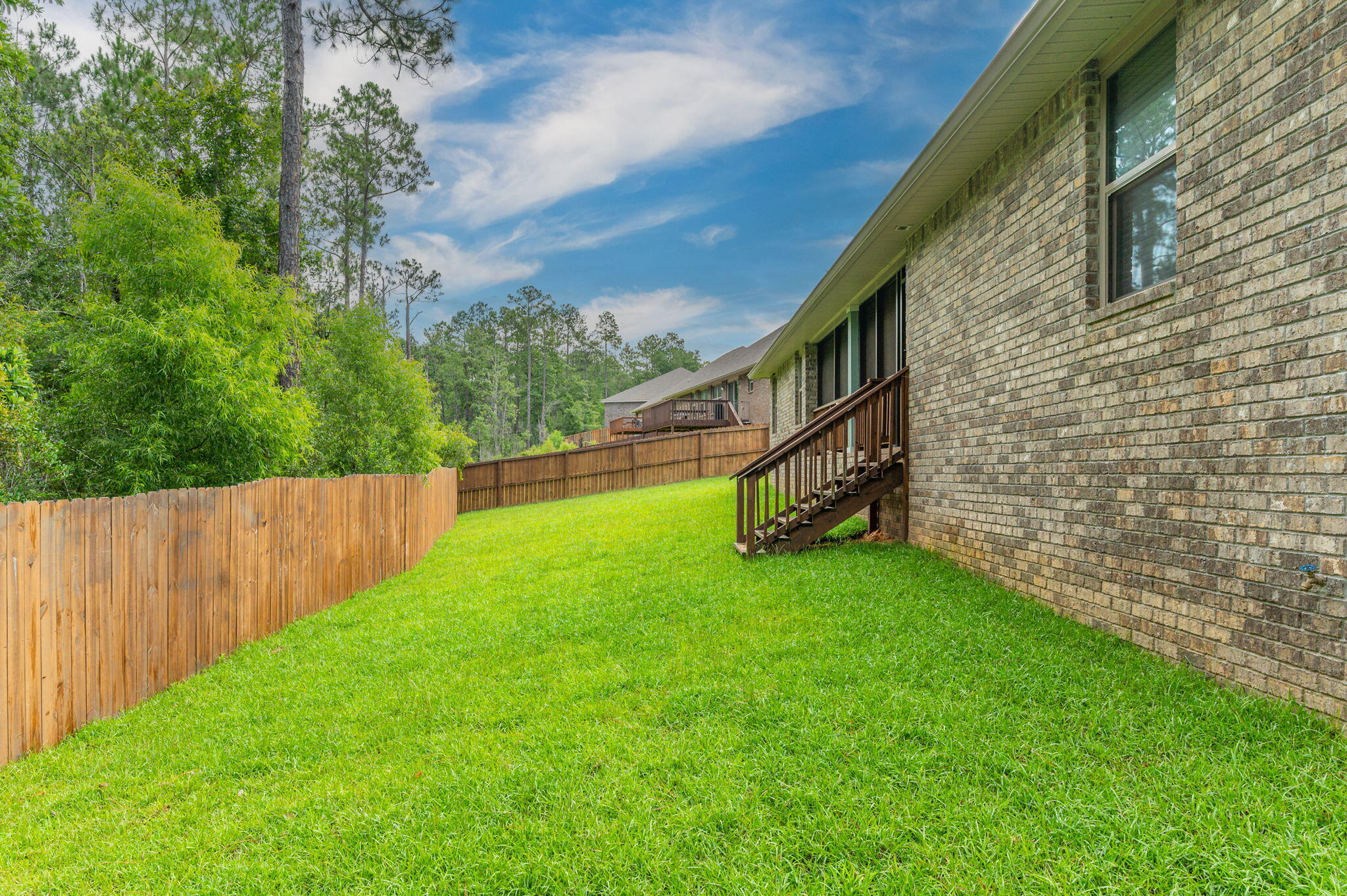605 Terrier Trail Crestview, FL 32536 - Photo 41 of 46 a view of an house with backyard and a garden