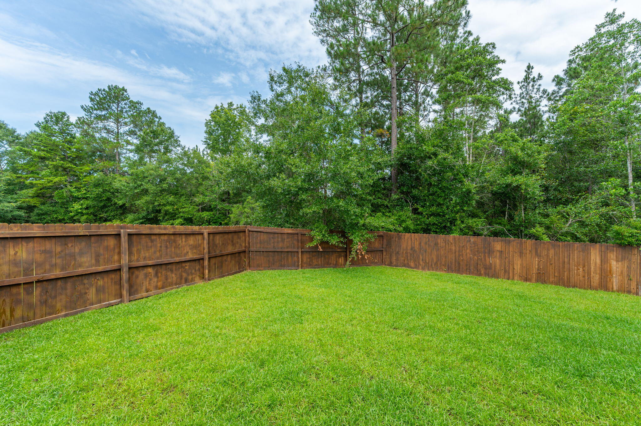 605 Terrier Trail Crestview, FL 32536 - Photo 42 of 46 a view of a backyard with a fence and wooden fence