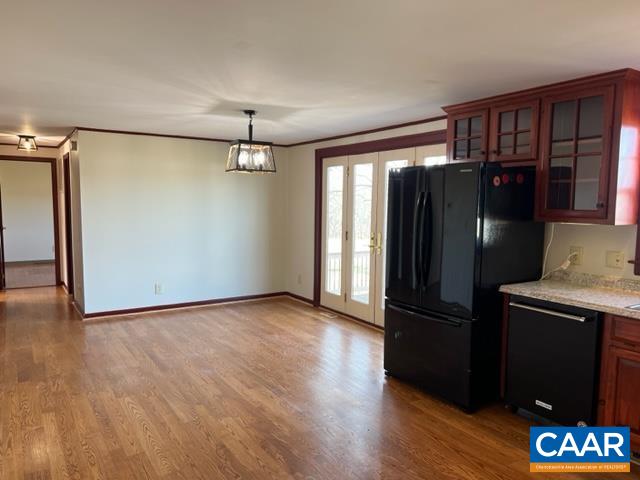 976 Douglas Church Road Farmville, VA 23901 - Photo 13 of 37 an empty room with wooden floor cabinet and a refrigerator
