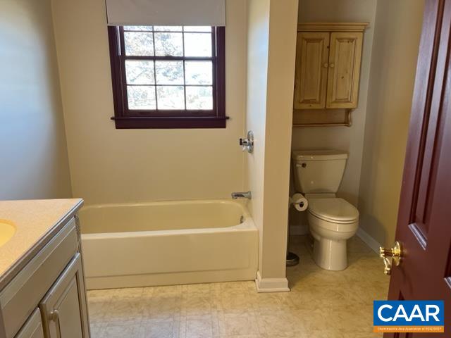976 Douglas Church Road Farmville, VA 23901 - Photo 23 of 37 a bathroom with a granite countertop toilet a sink and a bathtub