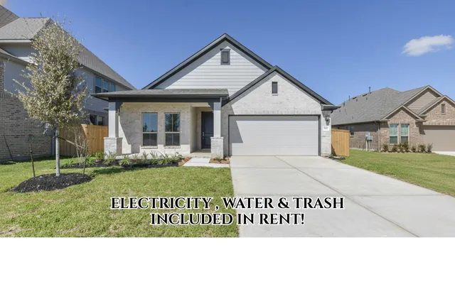 a view of a white house with a big yard and potted plants