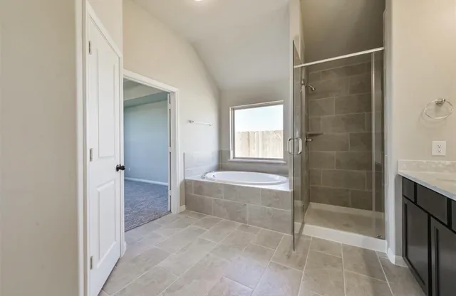a bathroom with a shower and a bathtub