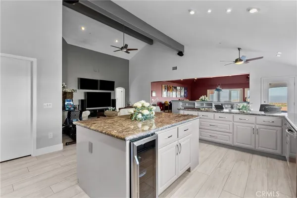 a kitchen with stainless steel appliances granite countertop a stove cabinets and wooden floor