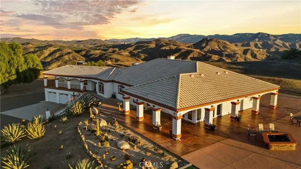 an aerial view of a house with a big yard