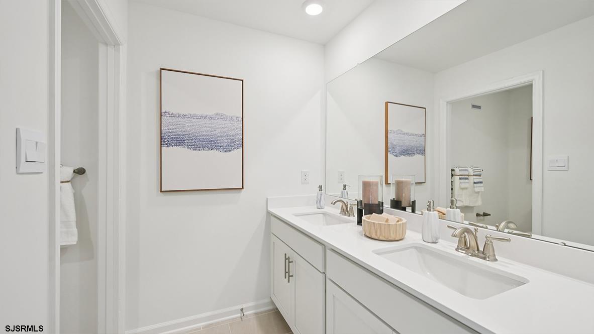 502 Scotty Boulevard, Unit 1202 Rio Grande, NJ 08242 - Photo 33 of 40 a bathroom with 2 sink and a mirror