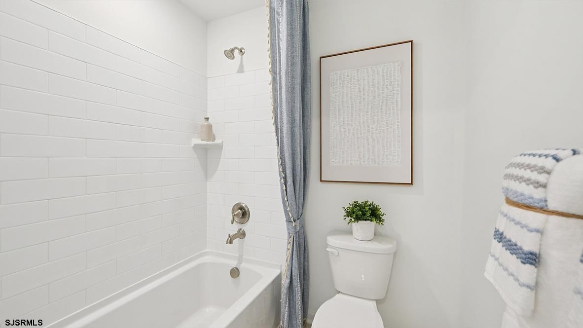 502 Scotty Boulevard, Unit 1202 Rio Grande, NJ 08242 - Photo 34 of 40 a white bath tub sitting next to a white toilet