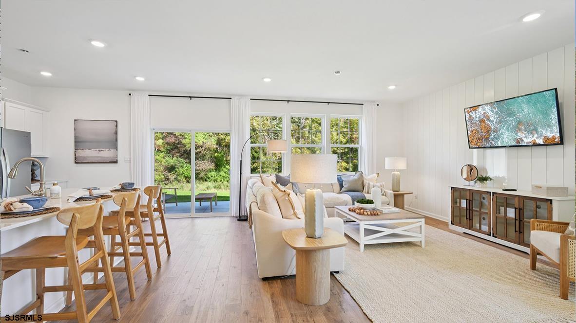 502 Scotty Boulevard, Unit 1202 Rio Grande, NJ 08242 - Photo 8 of 41 a living room with furniture and a flat screen tv