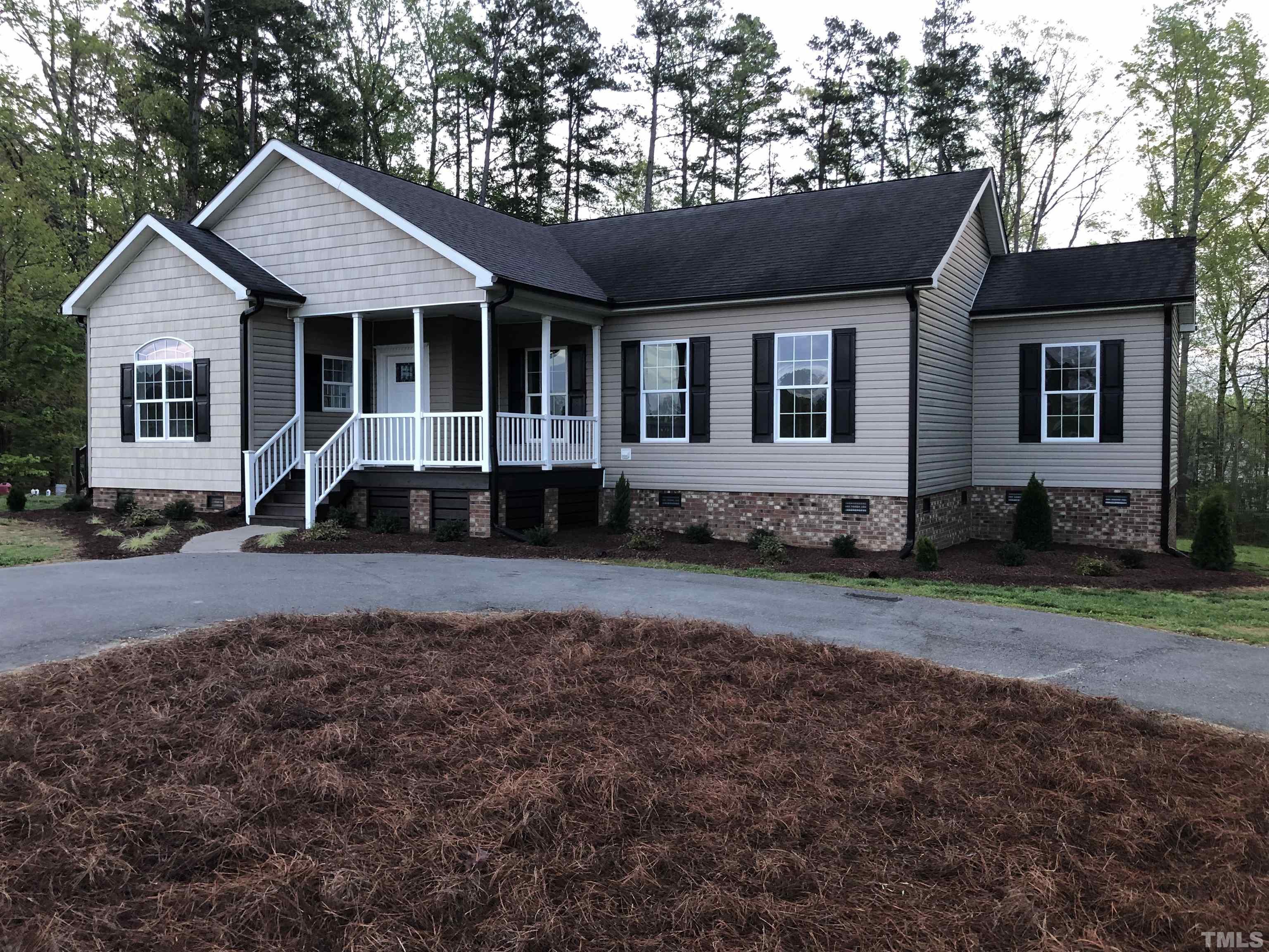 135 Satterfield Farm Road Timberlake, NC 27583 - Photo 1 of 37 a front view of a house with a yard