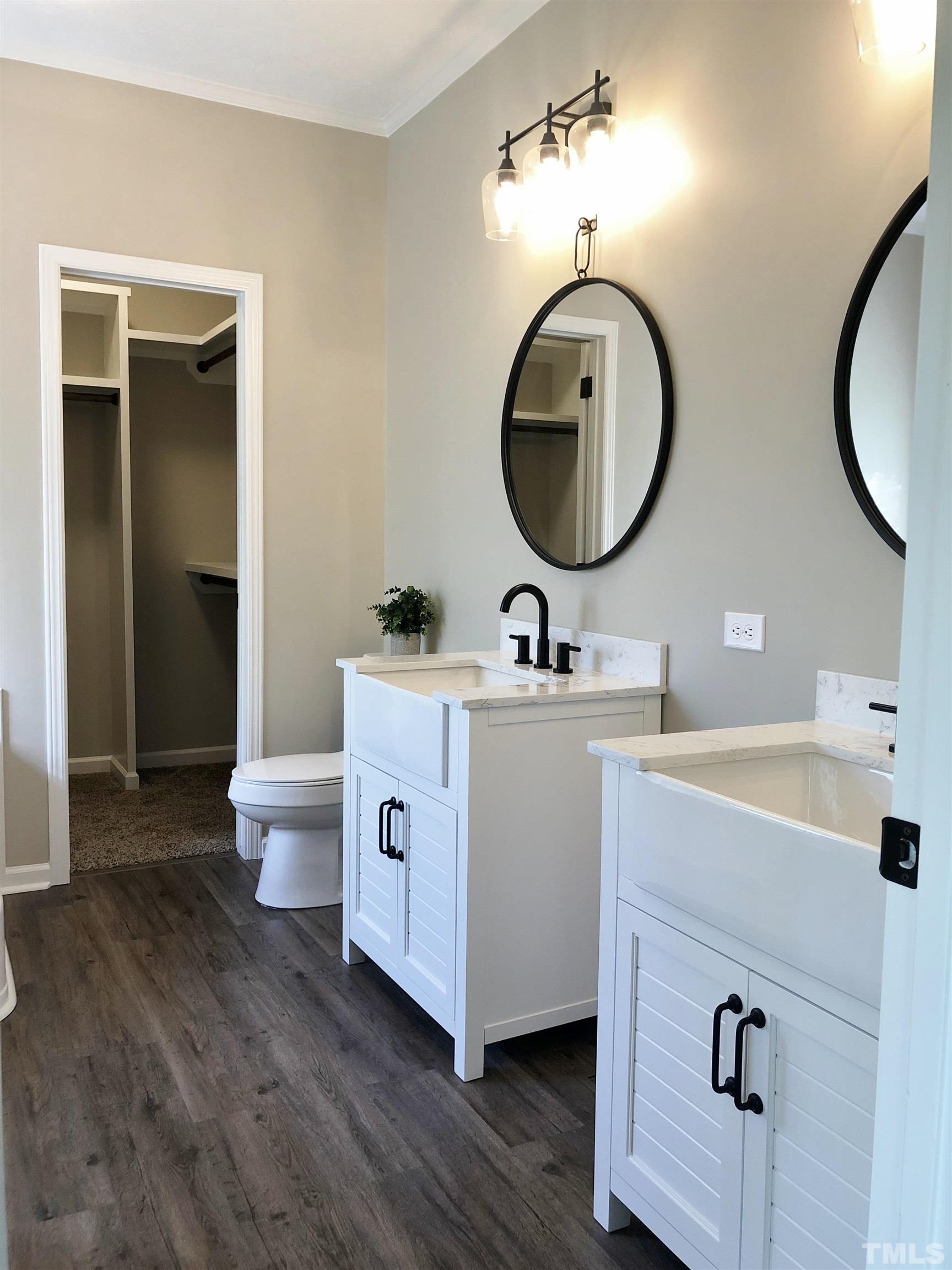 135 Satterfield Farm Road Timberlake, NC 27583 - Photo 15 of 37 a bathroom with a toilet a sink and a mirror
