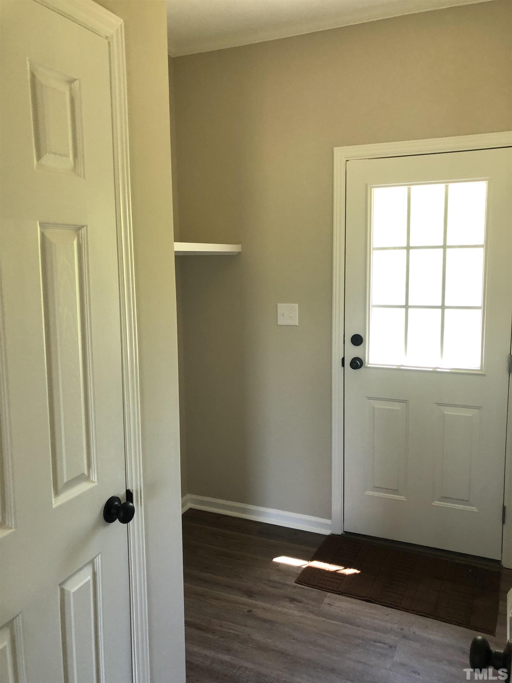 135 Satterfield Farm Road Timberlake, NC 27583 - Photo 20 of 37 an empty room with wooden floor and a window