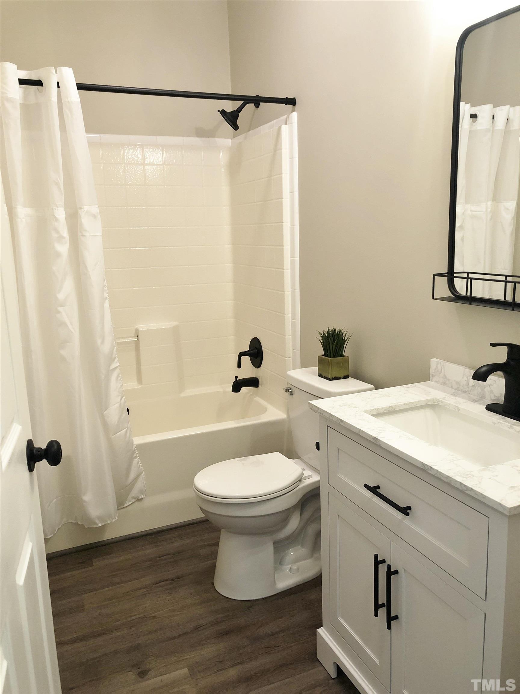 135 Satterfield Farm Road Timberlake, NC 27583 - Photo 23 of 37 a bathroom with a sink a toilet and a mirror