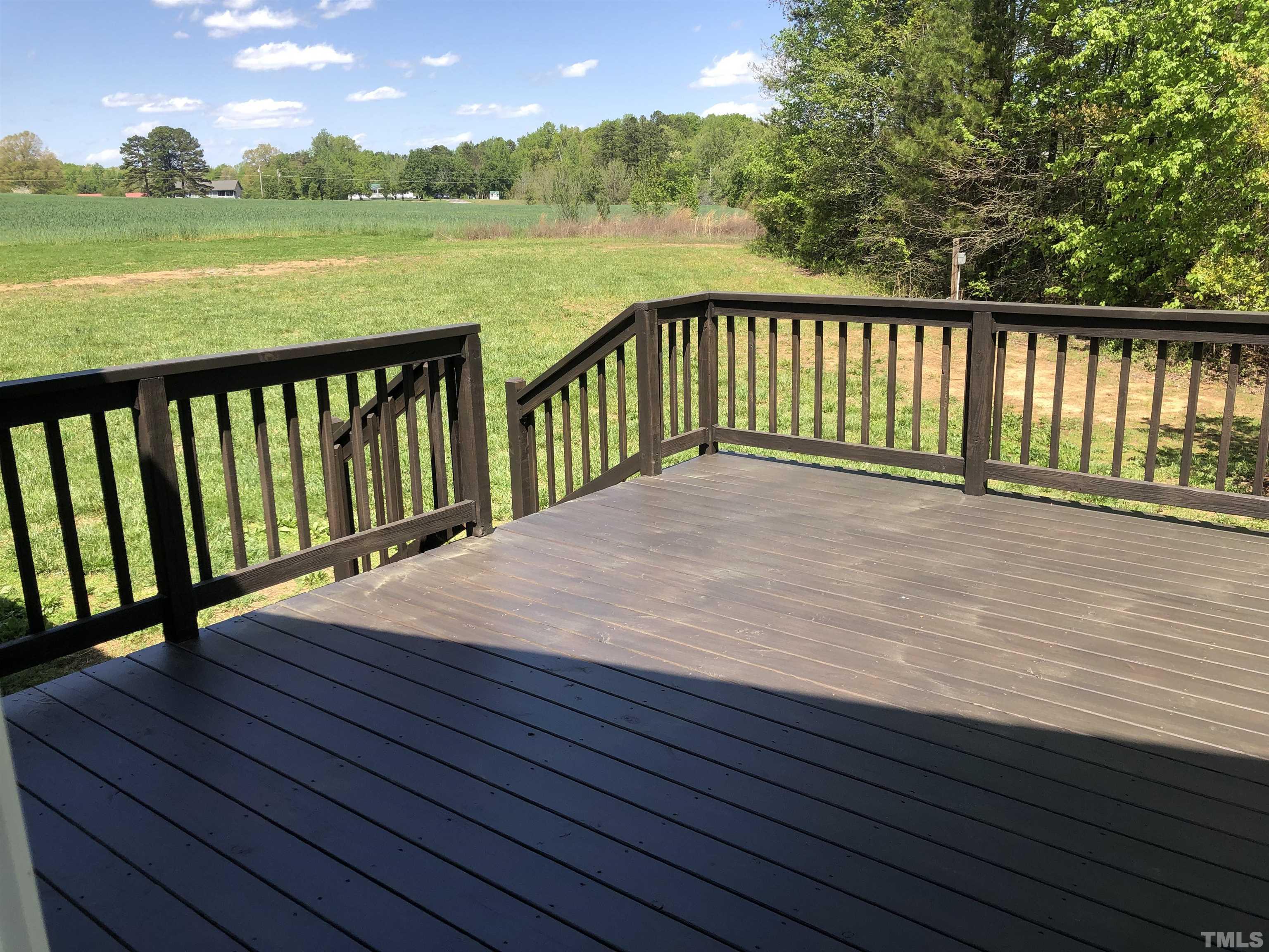135 Satterfield Farm Road Timberlake, NC 27583 - Photo 27 of 37 a view of wooden deck with lake view