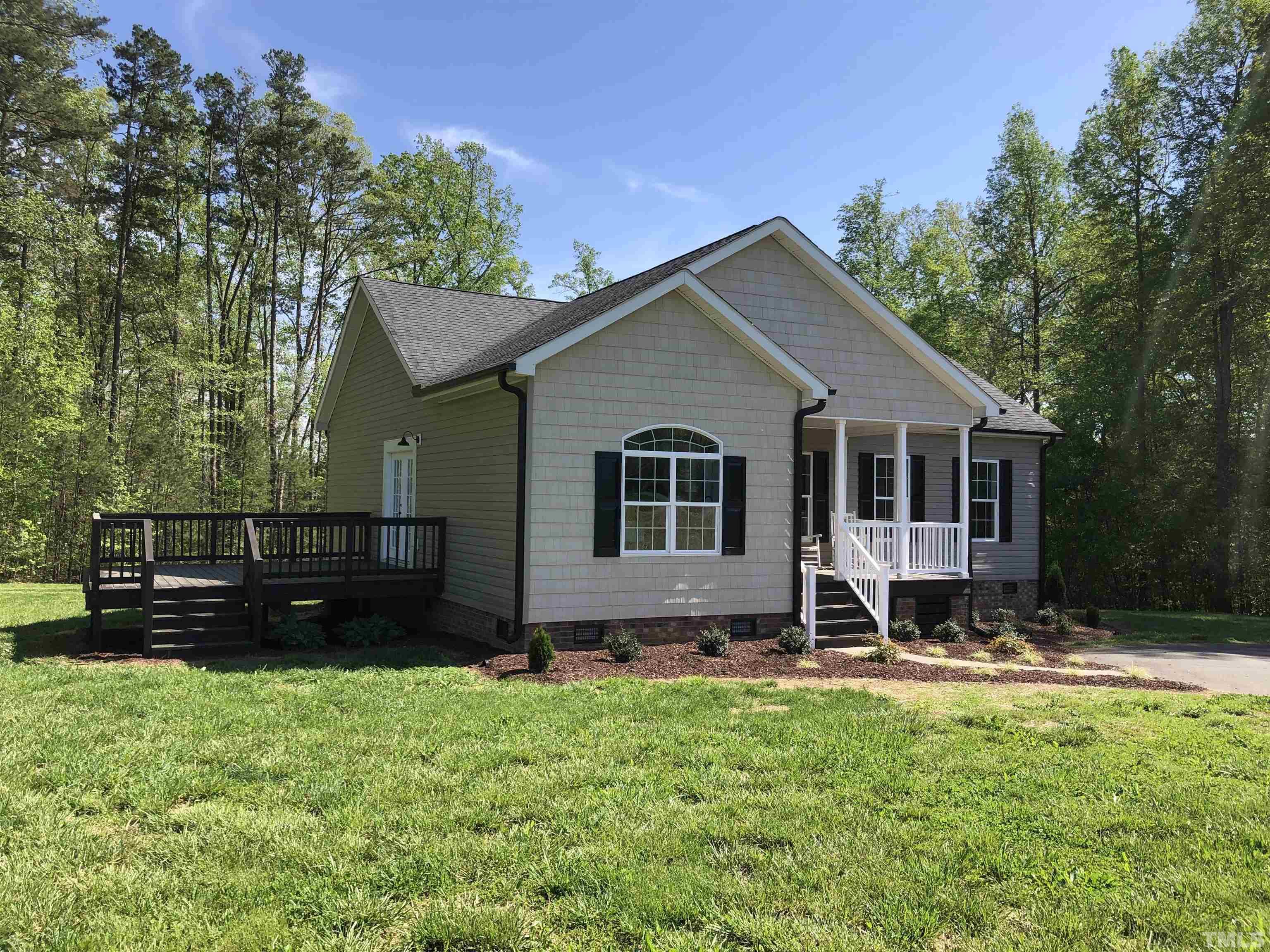 135 Satterfield Farm Road Timberlake, NC 27583 - Photo 35 of 37 a front view of a house with a yard