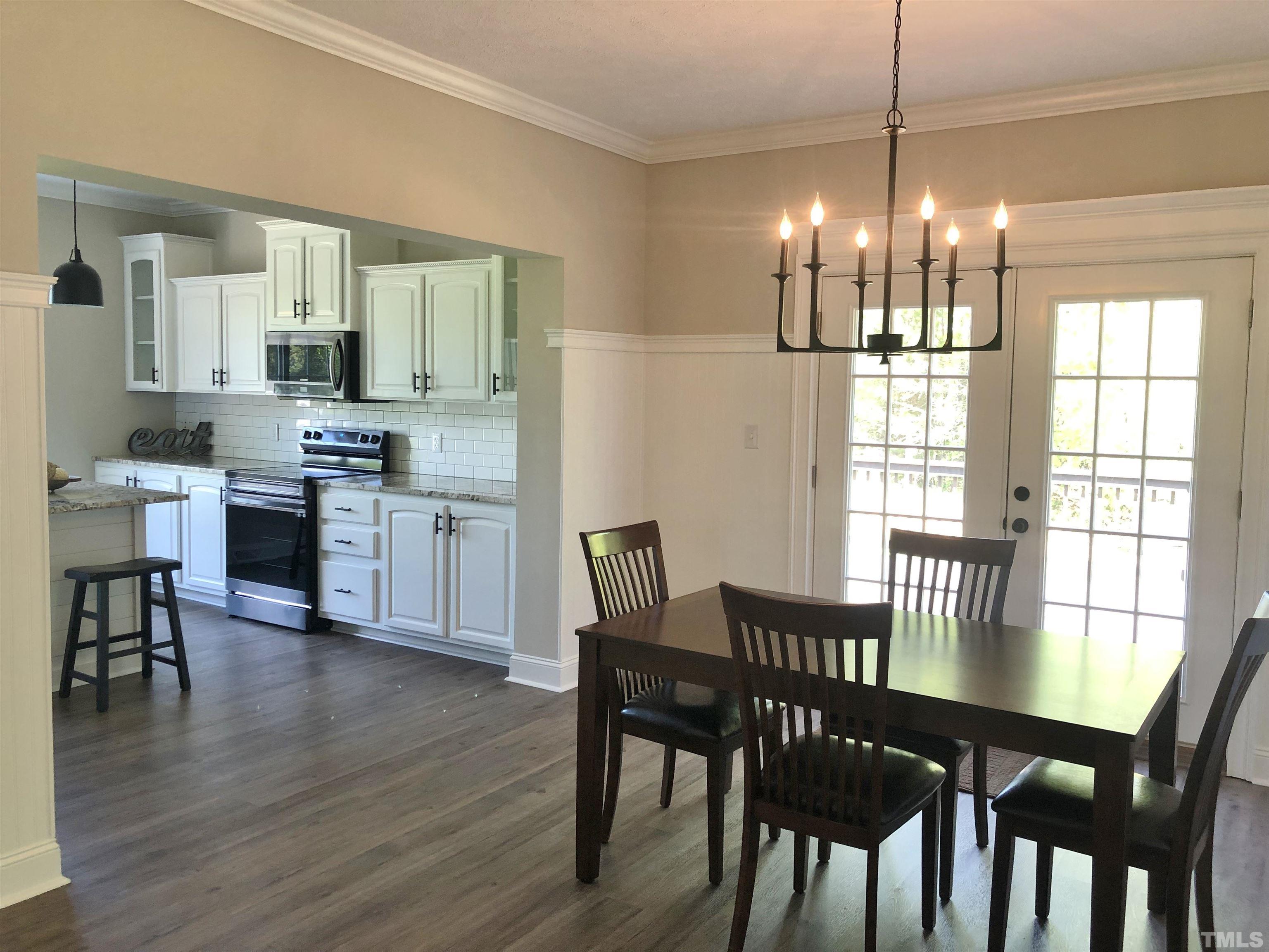 135 Satterfield Farm Road Timberlake, NC 27583 - Photo 6 of 37 a view of a dining room with furniture window and wooden floor