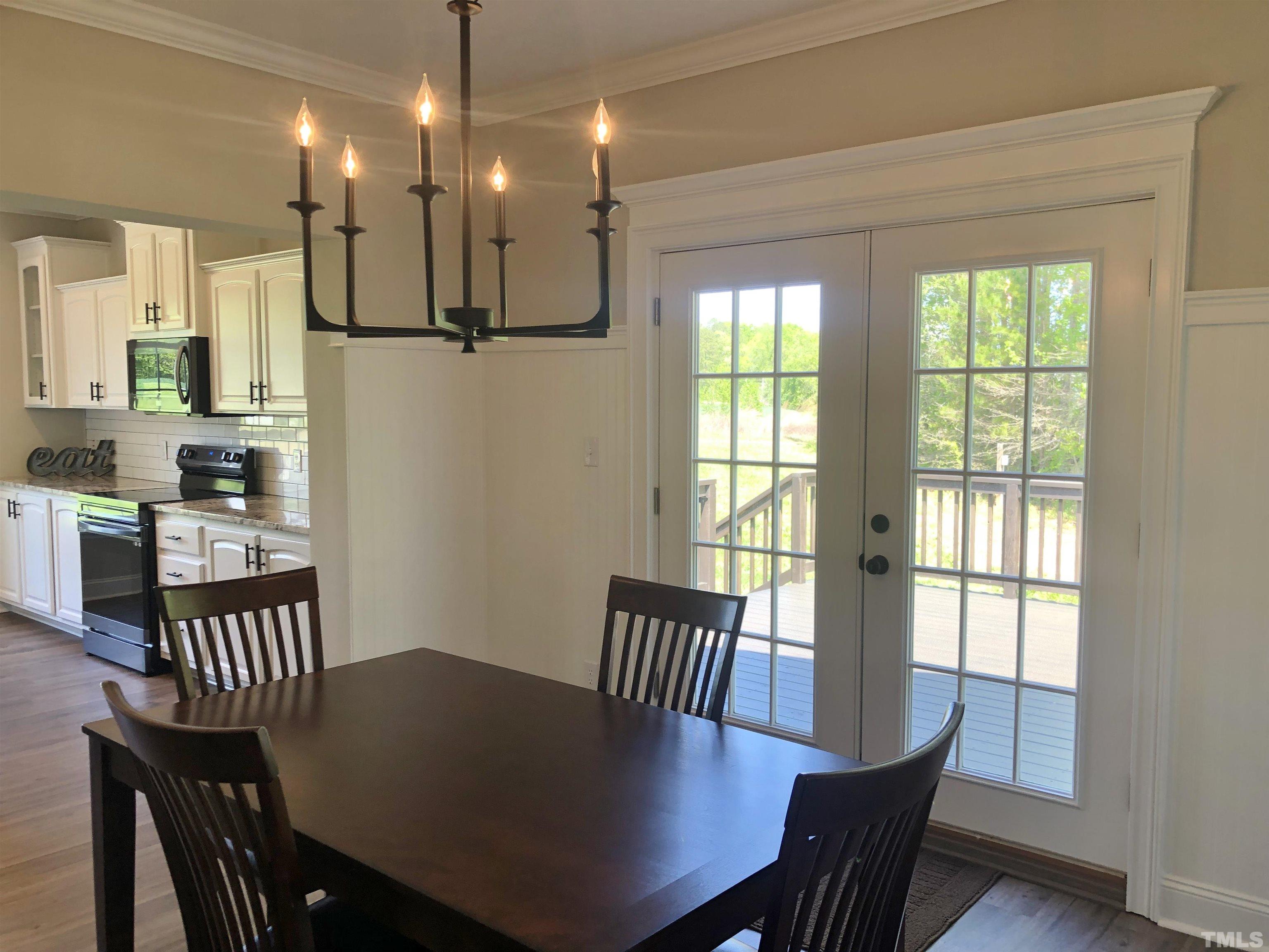 135 Satterfield Farm Road Timberlake, NC 27583 - Photo 7 of 37 a view of a dining room with furniture window and wooden floor