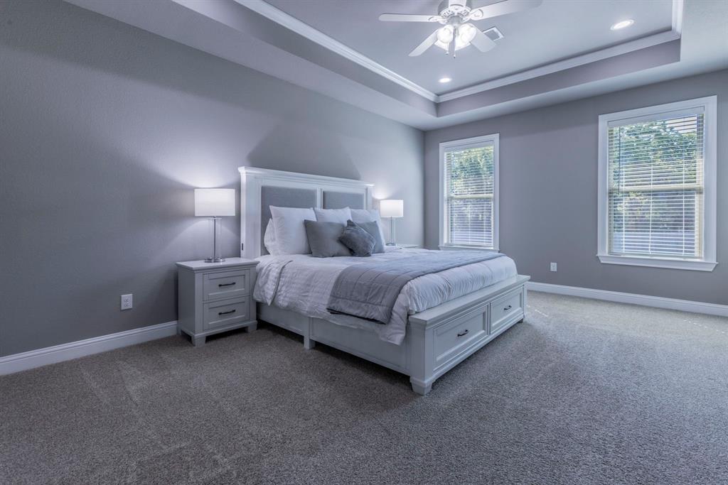 233 Fox Run Lane Robinson, TX 76706 - Photo 11 of 26 a bedroom with a bed and a chandelier