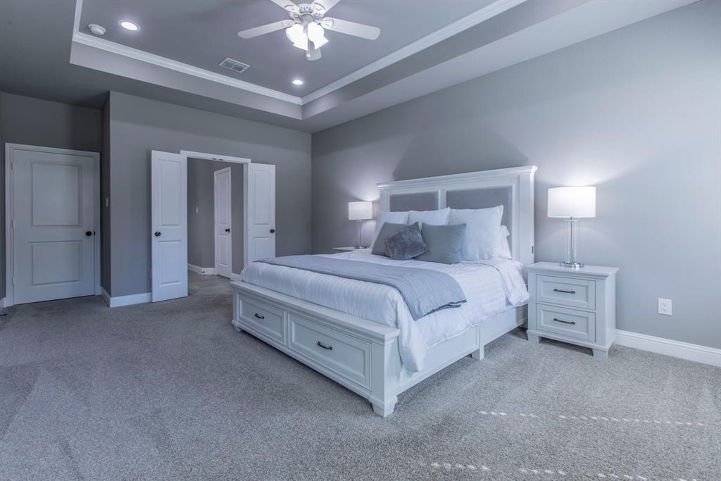 233 Fox Run Lane Robinson, TX 76706 - Photo 12 of 26 a bedroom with a bed and a chandelier