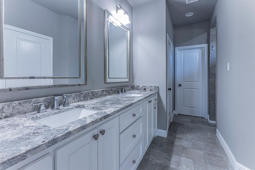 233 Fox Run Lane Robinson, TX 76706 - Photo 13 of 26 a bathroom with a granite countertop sink and a mirror