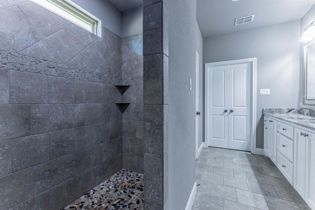 233 Fox Run Lane Robinson, TX 76706 - Photo 14 of 26 a bathroom with a sink a toilet and shower