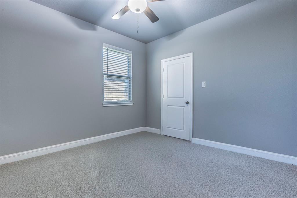 233 Fox Run Lane Robinson, TX 76706 - Photo 18 of 26 an empty room with a window and ceiling fan