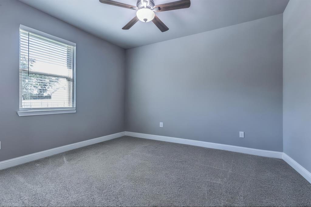 233 Fox Run Lane Robinson, TX 76706 - Photo 19 of 26 an empty room with a window and a fan