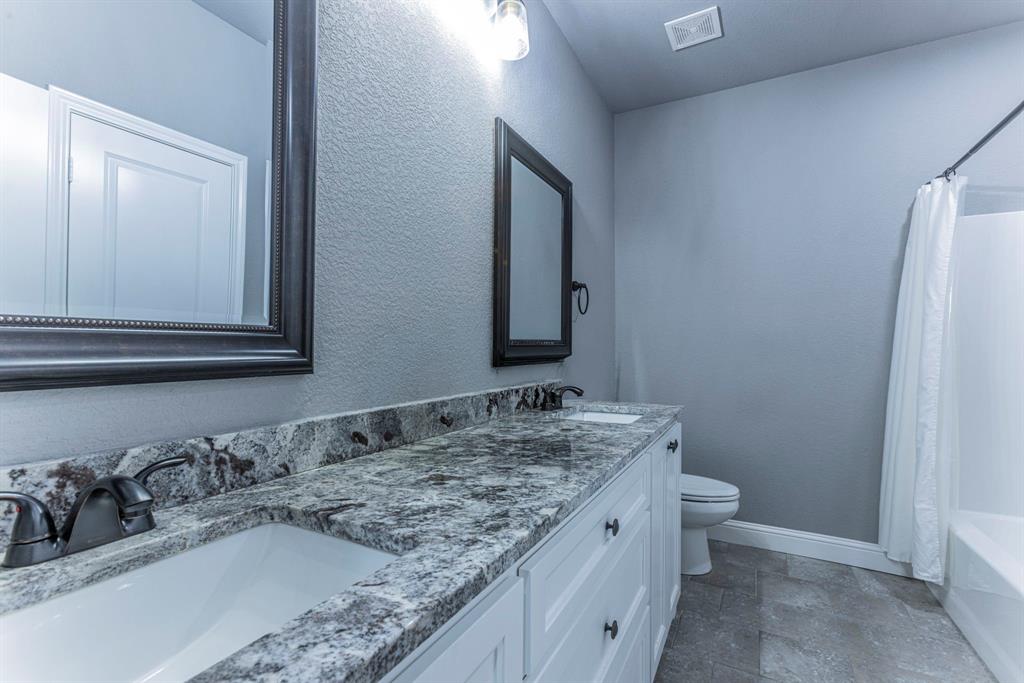 233 Fox Run Lane Robinson, TX 76706 - Photo 20 of 26 a bathroom with a granite countertop sink and a mirror