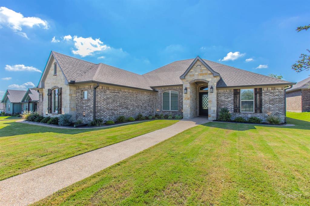 233 Fox Run Lane Robinson, TX 76706 - Photo 2 of 26 a front view of a house with a garden and yard