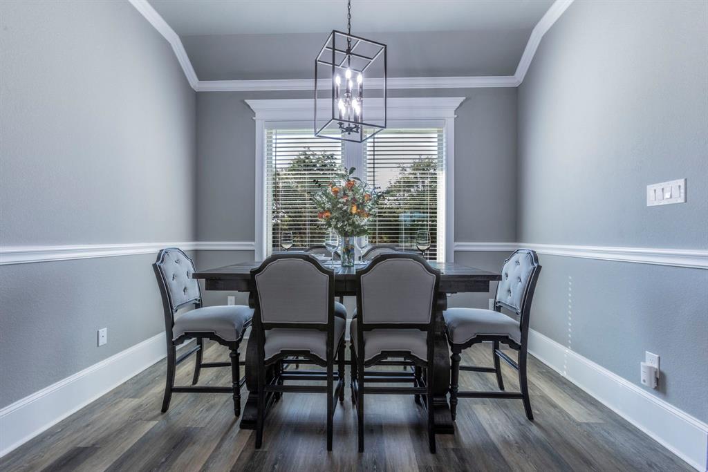 233 Fox Run Lane Robinson, TX 76706 - Photo 7 of 26 a view of a dining room with furniture a chandelier and wooden floor