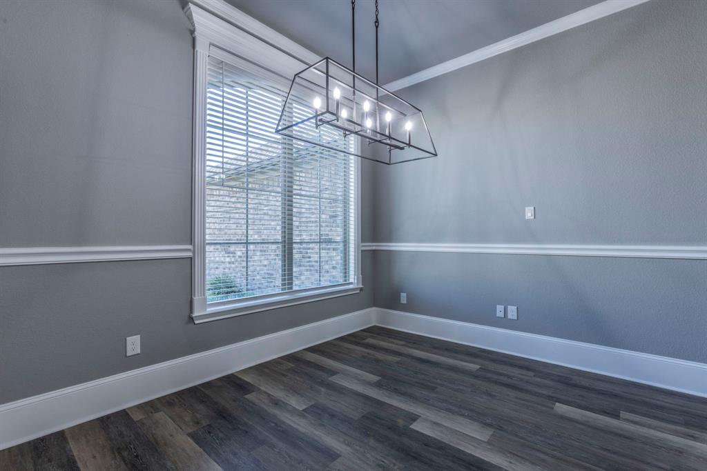 233 Fox Run Lane Robinson, TX 76706 - Photo 8 of 26 a view of a room with wooden floor and chandelier