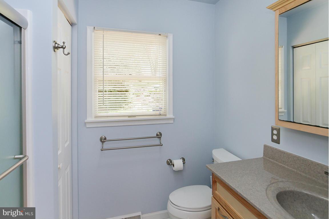 2209 Furnace Road Fallston, MD 21047 - Photo 19 of 30 a bathroom with a granite countertop toilet a sink a mirror and a window