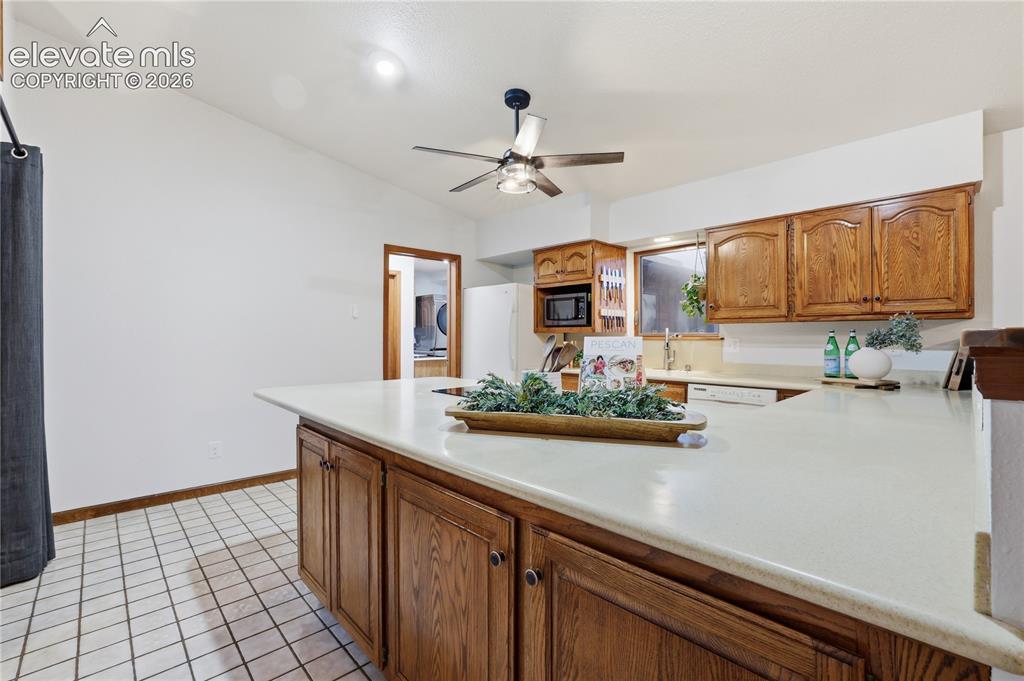 18190 Forest View Road Monument, CO 80132 - Photo 14 of 50 a kitchen with sink cabinets and window
