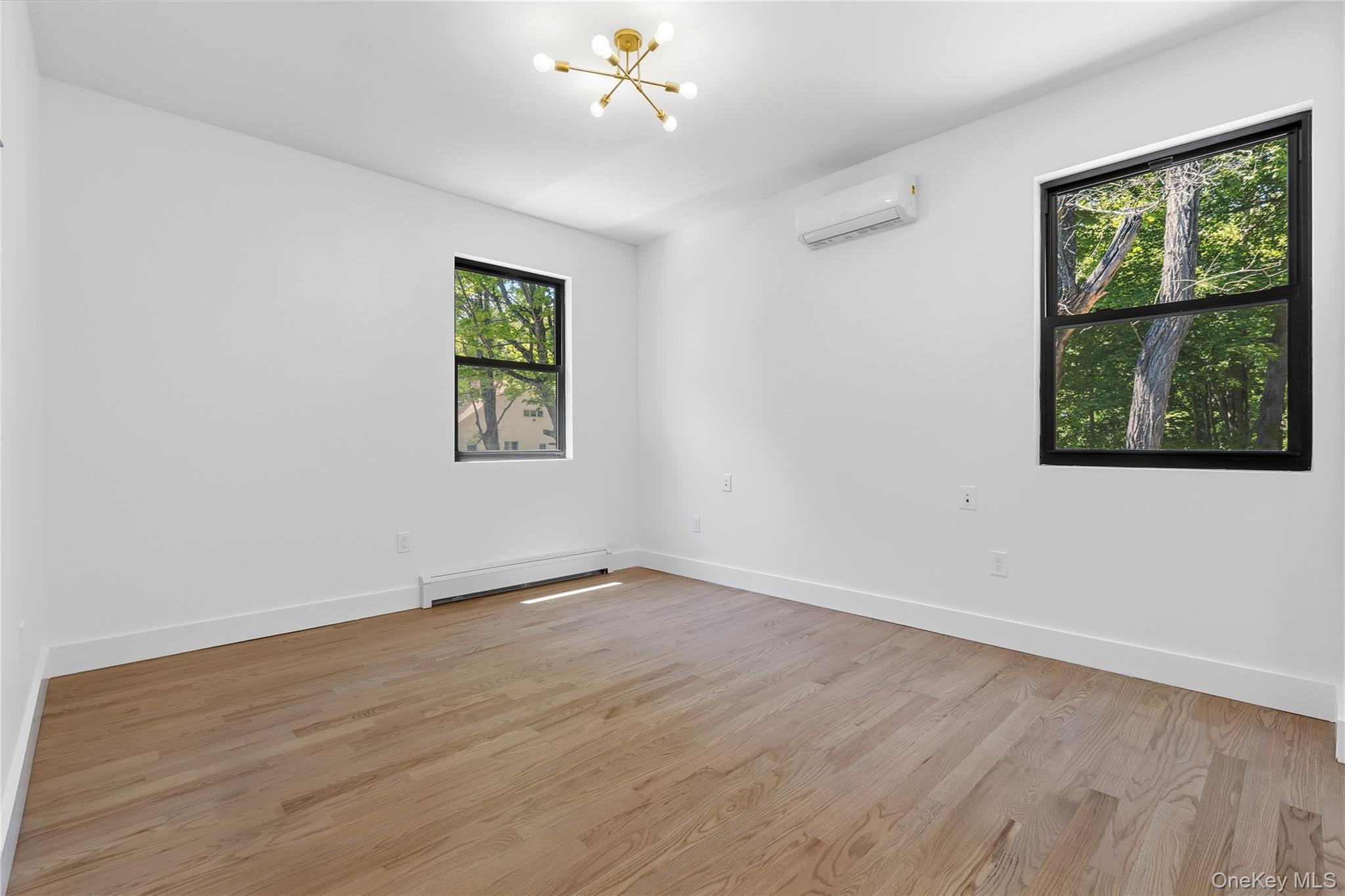 548 Lakes Road Monroe, NY 10950 - Photo 32 of 50 a view of an empty room with wooden floor and a window