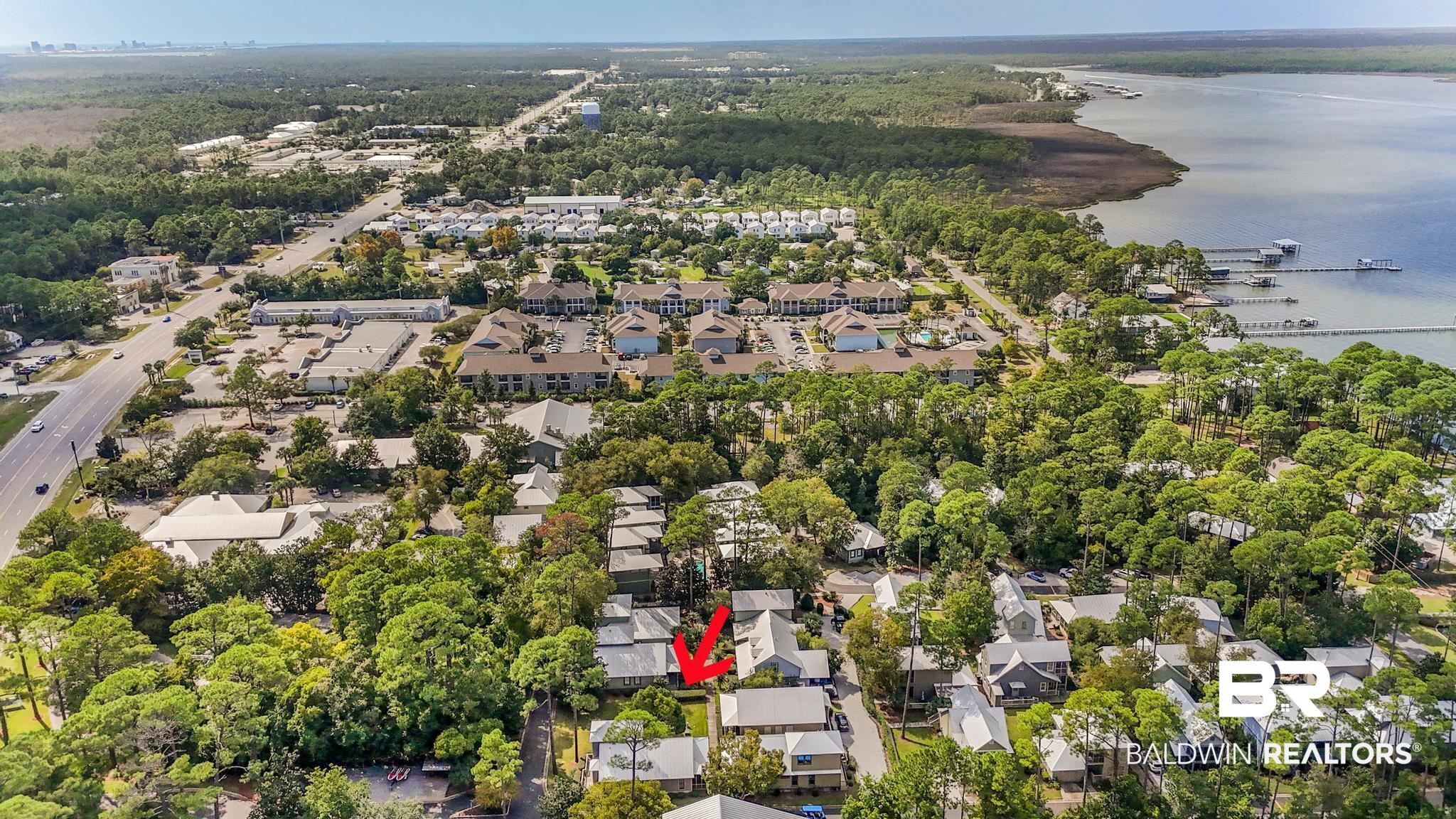 25773 Canal Road Orange Beach, AL 36561 - Photo 13 of 32 Aerial view of property and surrounding area with nearby suburban area and a nearby body of water