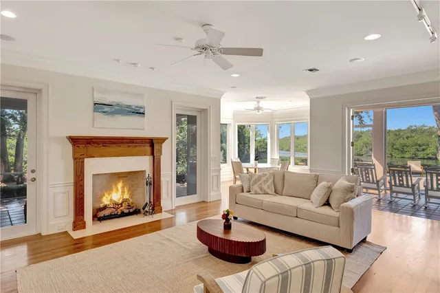 a living room with furniture a fireplace and a large window