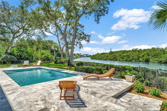 a view of a lake with a garden and swimming pool