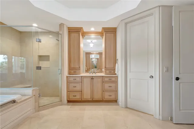 a bathroom with a granite countertop sink a toilet and shower