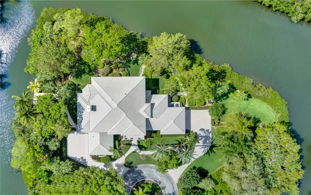 an aerial view of a house with a yard and garden in back